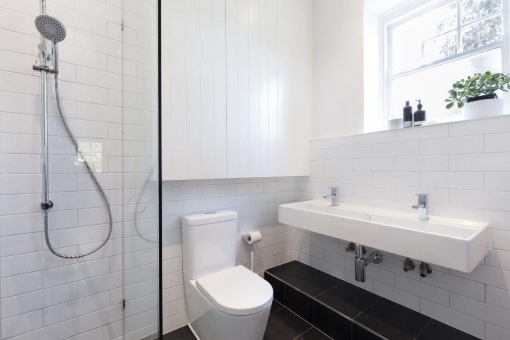 Small ensuite bathroom with white tiling laid in brick pattern | 8 Tips For Small Bathroom Renovations In NYC | DCON Renovations New York - Brooklyn | Remodeling - Architectural Design - Residential Contractor - Brownstoner Experts